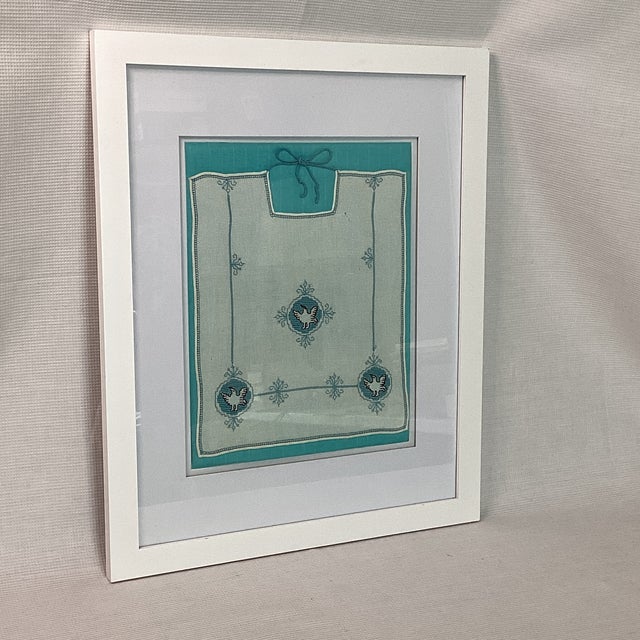 Vintage 1930s child's bib, hand embroidered little birds, blue and black on off-white linen Modern frame and mat, under...