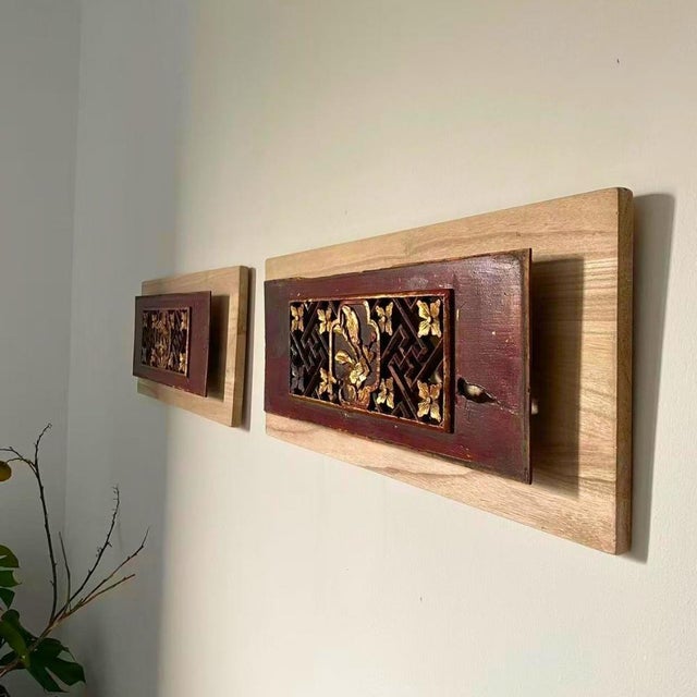 A sculptural wall art composition composed of two early 20th-century Chinese giltwood openwork floral carvings, each...