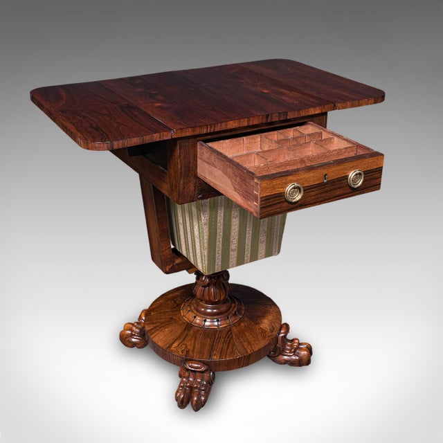 This is an antique ladies hobby table. An English, rosewood drop leaf sewing or parlour table, dating to the William IV...