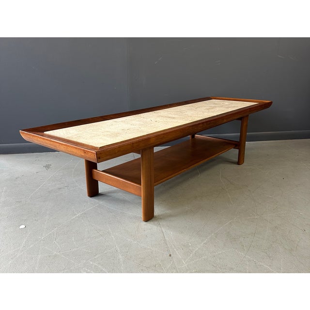 Expertly crafted from a stunning combination of travertine and walnut, the Widdicomb Coffee Table designed by Dale Ford...