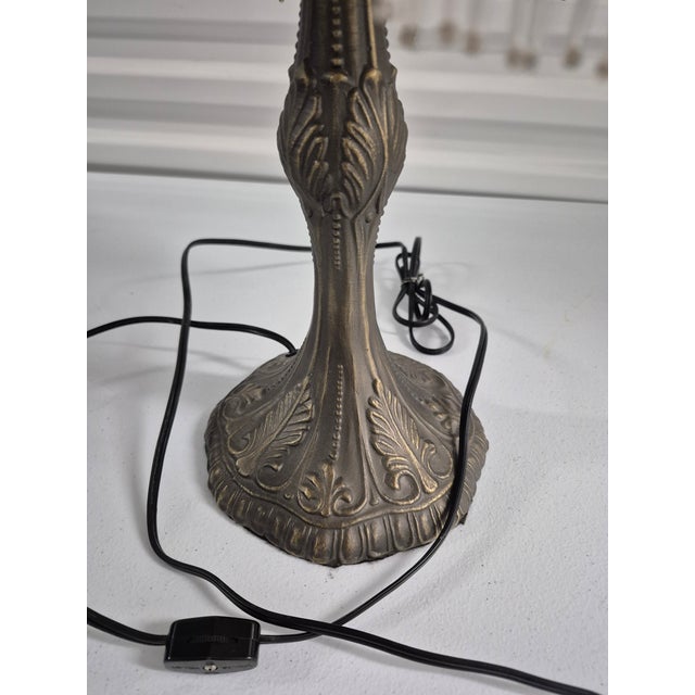 This is an ornate Victorian-style table lamp featuring a scalloped, fabric shade adorned with dense, tiered glass bead...