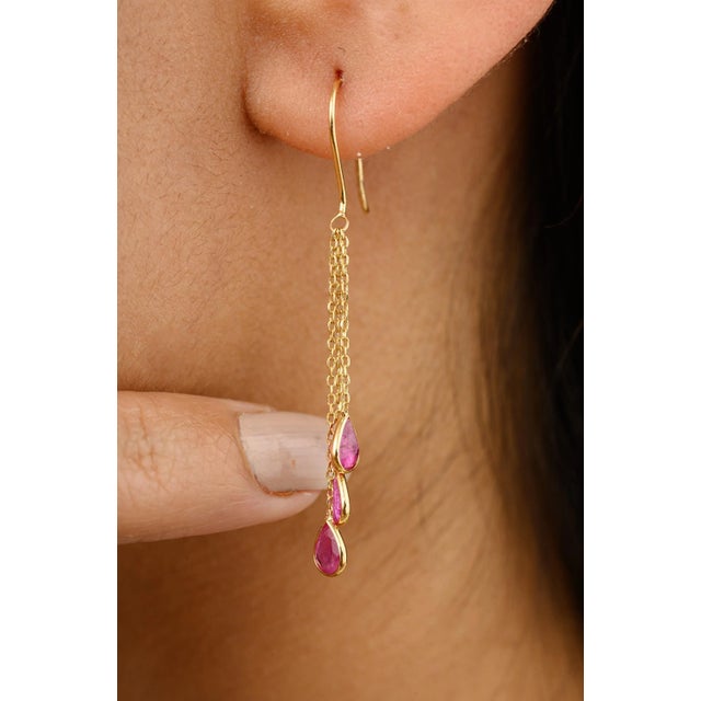This is part of Chairish’s Fine Jewelry assortment. Adorn your ears with ethereal elegance in these tear drop ruby dangle...