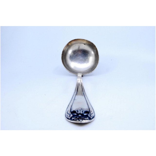 Silver Soup Ladle with Raised Handle Strip and Monogram Card, in Very Good conditions. Designed 1920 to 1949 This piece...