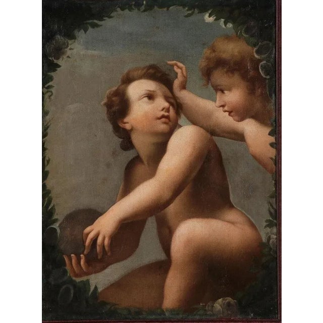 An antique, late 17th-century, c. 1690 Italian oil painting of a pair of putti, cherubs, or small children playing with a...