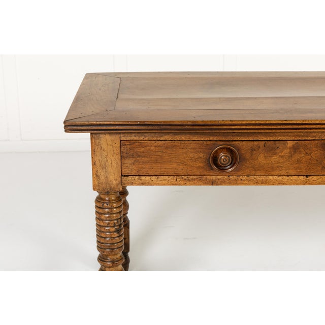 A late 19th century french walnut ‘drapière’ work table. the table top is constructed with a distinctive mitred frame...
