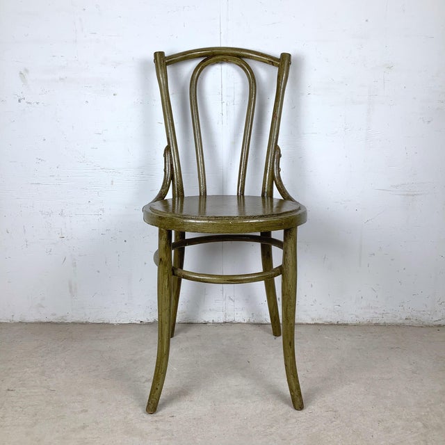 A classic bentwood café chair dating approximately 30–55 years old, inspired by the iconic Thonet café silhouettes. The...