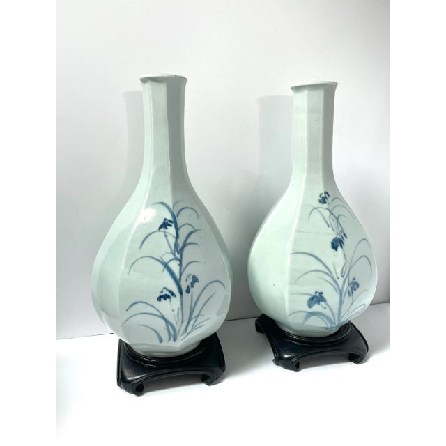 Pair of Asian celadon glazed vases with watercolor floral scenes in blue. Each vase has two unique, hand-painted scenes...