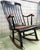 19th Hitchcock rocking chair with woven seat and black painted.