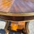 A refined and architecturally composed round center table crafted in the Empire Revival taste, showcasing a striking...