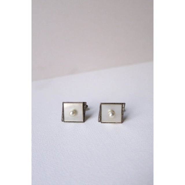A beautiful pair of white cultured pearl and mother of pearl cufflinks set in sterling silver, circa mid-20th century....