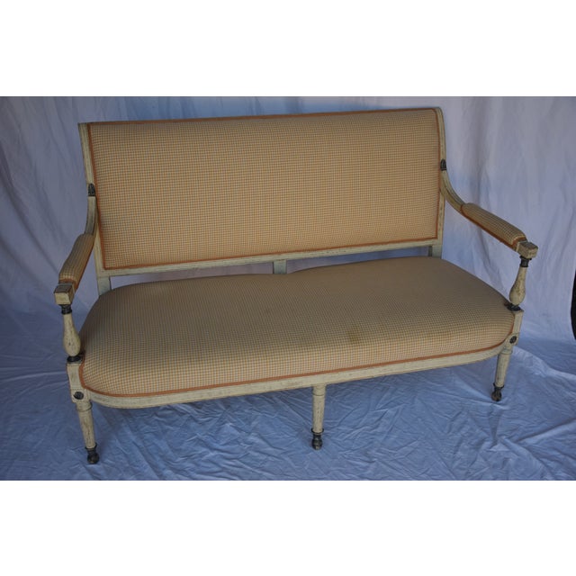 A beautiful Swedish settee suitable for bedrooms and living areas. The sofa frame is adorned with gilt accents on shaped...