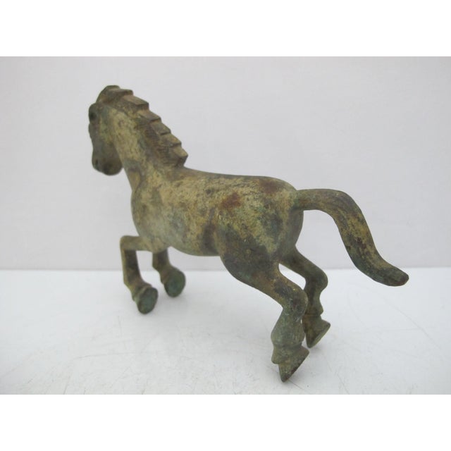 Small vintage bronze replica of a Han Dynasty galloping Horse figure featuring a green patina. Excellent condition. Very...