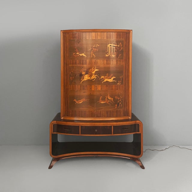 Italian Art Deco inlaid wood bar cabinet, 1930s Inlaid wood bar cabinet. The upper section features a compartment with...