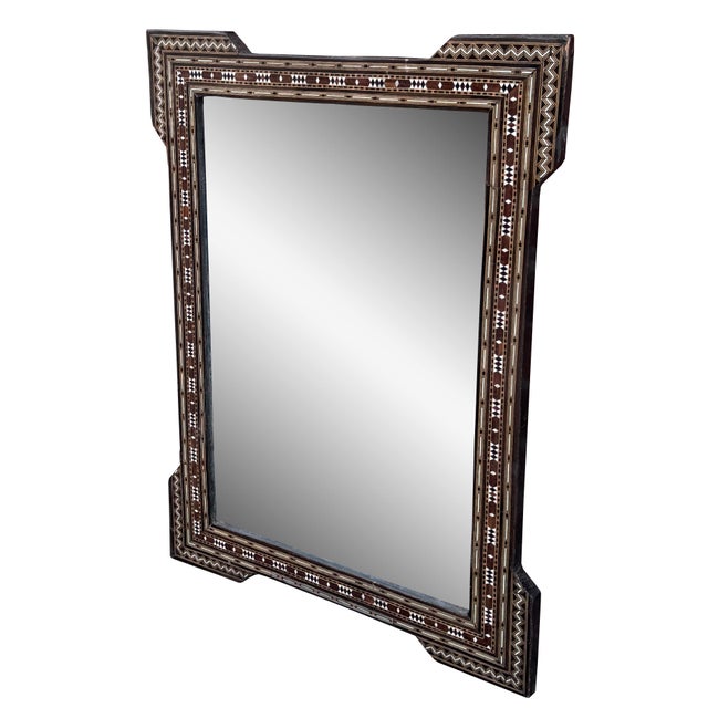 An exquisite mid 20th century Syrian mirror showcasing traditional mosaic inlay craftsmanship. The wooden frame is...