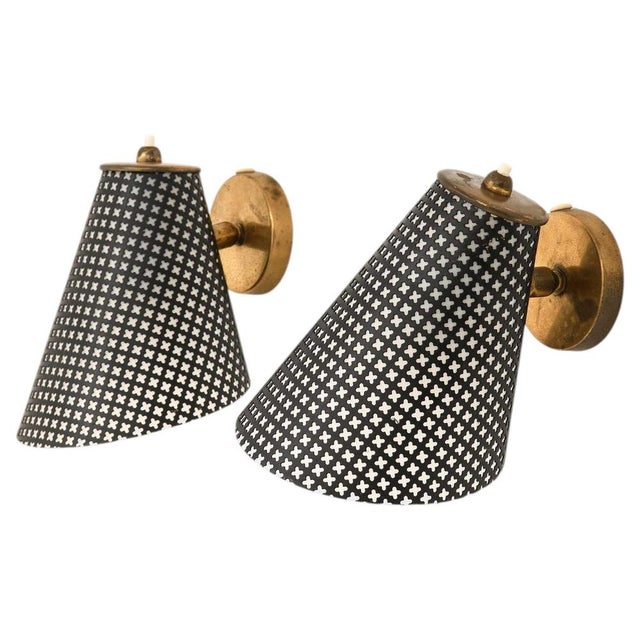 This refined pair of danish wall lamps, designer unknown, offers a quintessential expression of mid-century scandinavian...