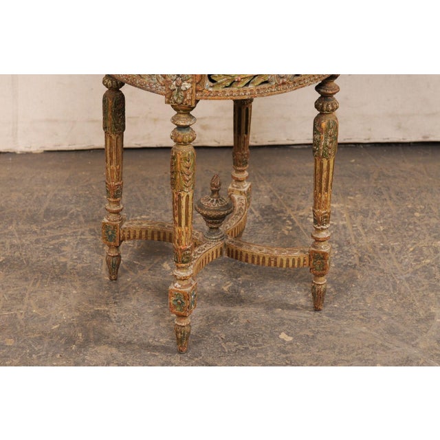A French Neoclassical carved and painted wood stool, with nicely upholstered seat, from the 19th century. This antique...