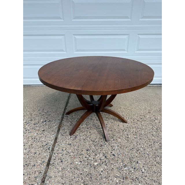 A striking Mid-Century Modern round dining table attributed to Chet Beardsley for Living Designs, showcasing a beautifully...