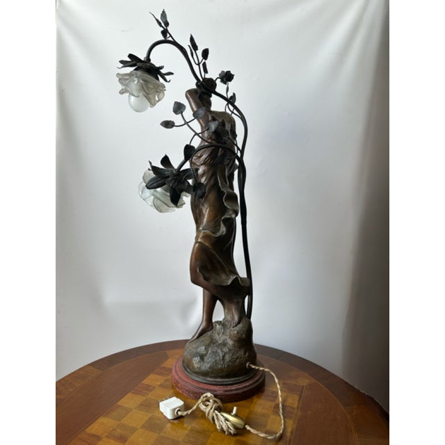 A vintage Art Nouveau sculpture lamp, dating back to around 1900, originally conceived as a pillar lamp. It depicts a...