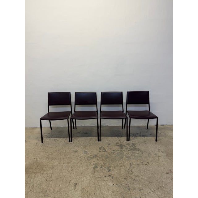 Set of four eggplant / aubergine / deep purple fully leather wrapped dining chairs by Frag Slr, Italy. Circa 2000s.