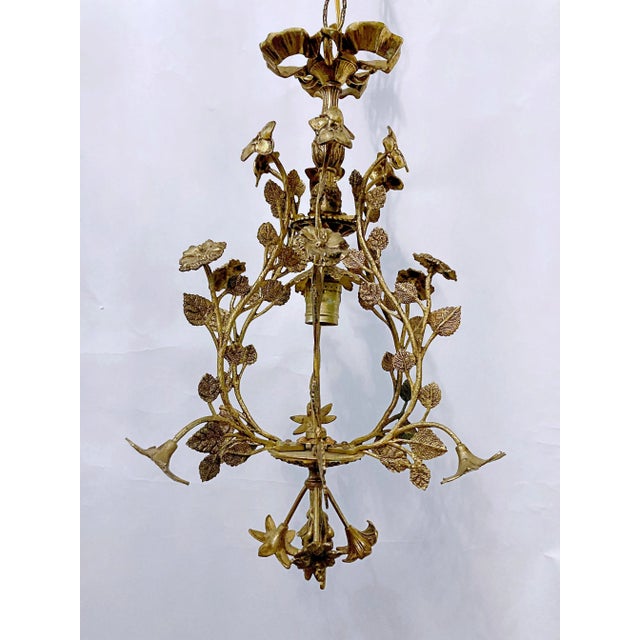 This a European decorative floral pendant with brass branches and flowers. It has one Edison based socket that can use 100...