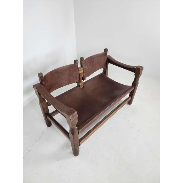 Mid-Century Brutalist Brown Leather Safari Bench in amazing condition. The back tilts to adjust your position, the leather...