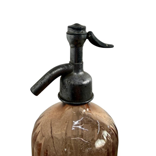 Original antique French seltzer bottle dating from the early 20th century, featuring its original cast metal siphon head...