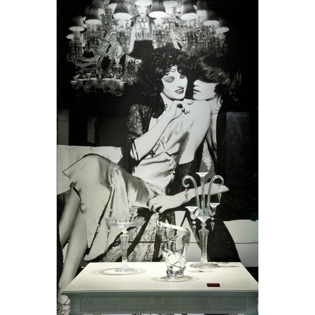 Elegant and well-proportioned French dining table with solid wood legs carved with ornamental motifs. Its New Classical...