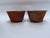 A matching pair of round tole bowls or cachepot featuring a terra cotta style finish and three ball feet.
