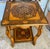 This is a gorgeous little side/tea table with fantastic marquetry inlay of various types of wood interspersed with mother...