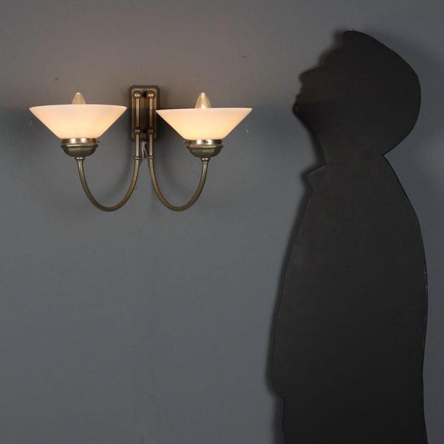 Vintage wall lamp with a metal frame and two light sources with glass diffusers. They feature two E14 sockets. This piece...