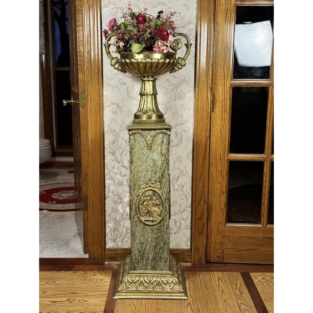 This pair of Empire style pedestal columns is made of green verde marble with dense natural veining and dressed with gilt...