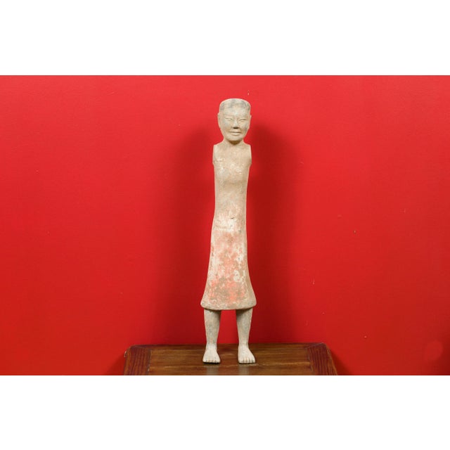 A Chinese Western Han dynasty period armless figurine with original polychromy. Born in China during the Western Han...