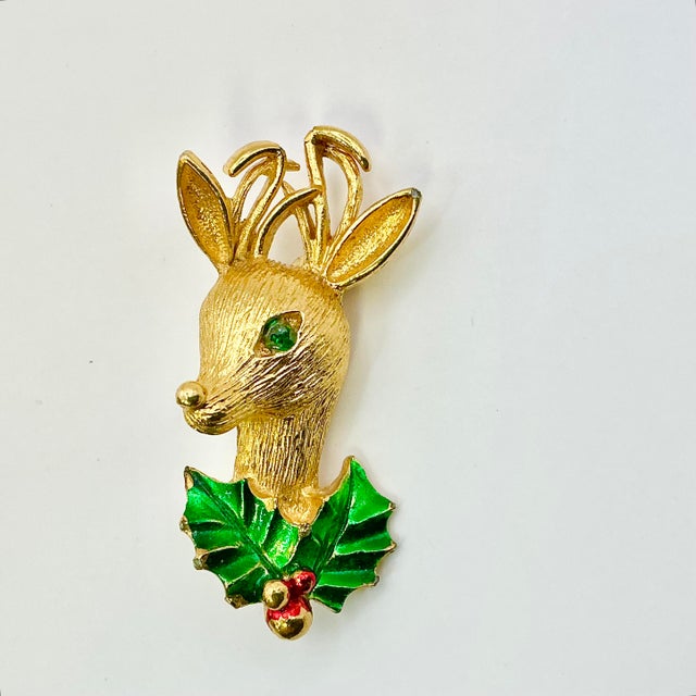 A lovely Christmas Brooch from Gerry’s Creatives from the 1970s. It features a lovely gold tone Reindeer Bust with two...