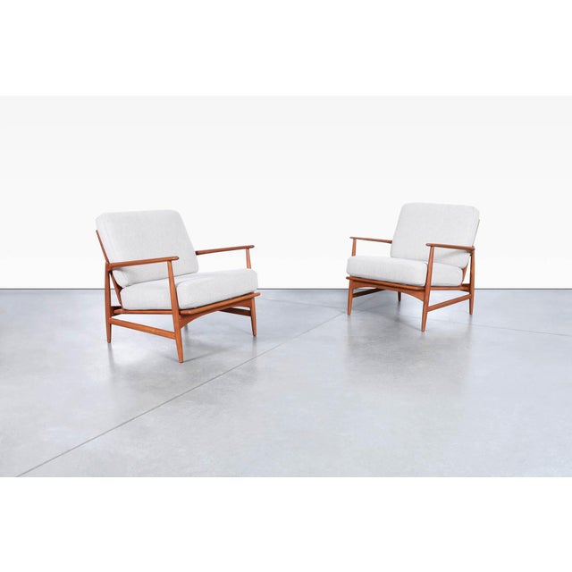 Danish modern teak lounge chairs designed by Ib Kofod-Larsen for Selig in Denmark, circa 1960s. A masterclass in...