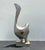 A sculptural abstract swan rendered in cast metal with a softly aged silver finish. Defined by sweeping organic lines and...