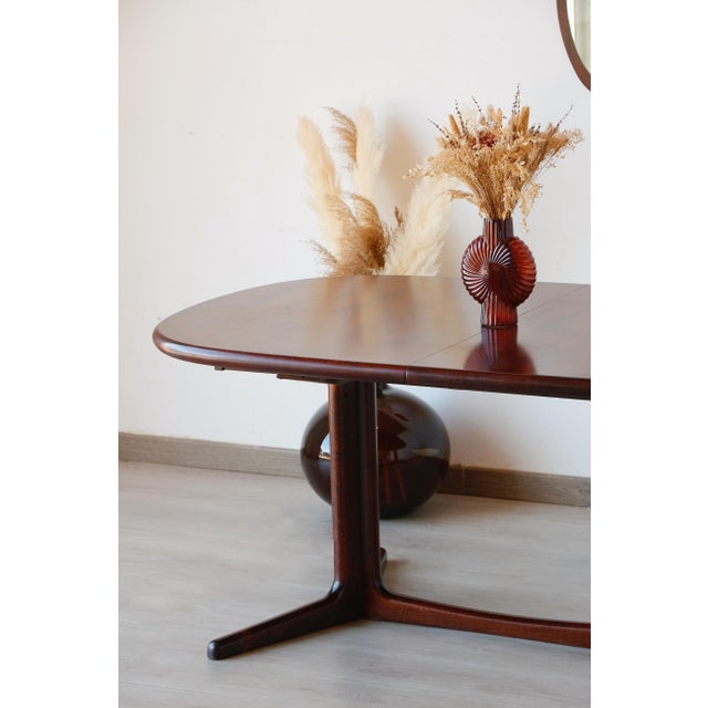 This extendable scandinavian table is a creation of the danish designer edvard valentinsen. It was manufactured in denmark...