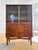 This Danish display cabinet is an exquisite example of 1950s craftsmanship and embodies early mid-century style at its...