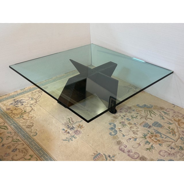Design Plus Gallery presents a Sculptural Glass Top Coffee Table. This table has a square glass top with a smoky tint and...