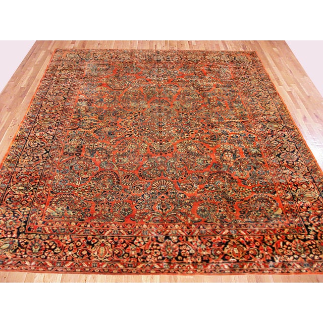 Antique Persian Sarouk Oriental rug, circa 1920, Room size. An antique Persian Sarouk oriental rug, size 11'9" x 8'7",...