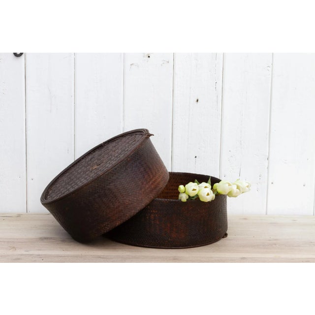 Antique storage basket from the Akha tribe in Thailand. A finely woven rattan basket that was originally used to store tea...