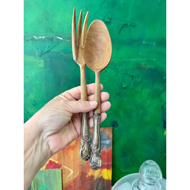 Beautiful French salad, tongues, with sterling, silver handles, and wood heads. Each handle is marked sterling. One is...