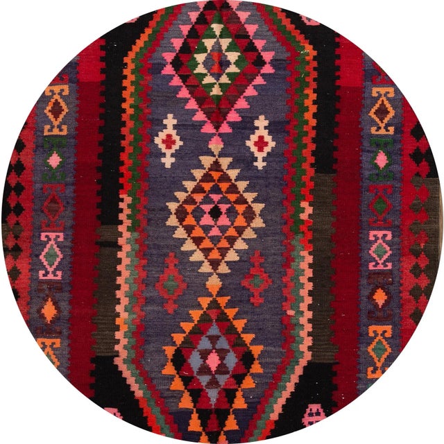 A beautiful hand-woven vintage kilim rug with a red field, and multi-color accents in an all-over geometric design. This...