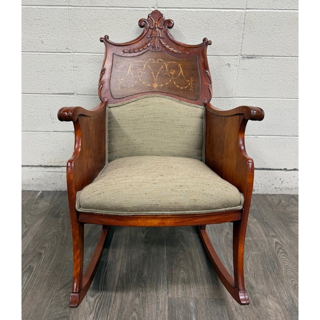 This is a unique and gorgeous antique Victorian mahogany rocking chair dating to the early 20th century. Beautifully...