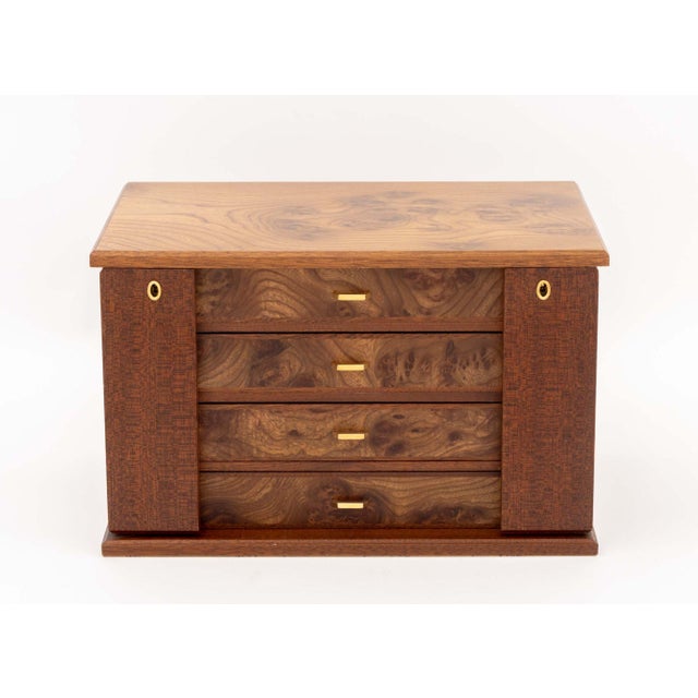 Agresti Burl Walnut Jewelry Box, with four central drawers with tan suede lining and two necklace compartments to each...