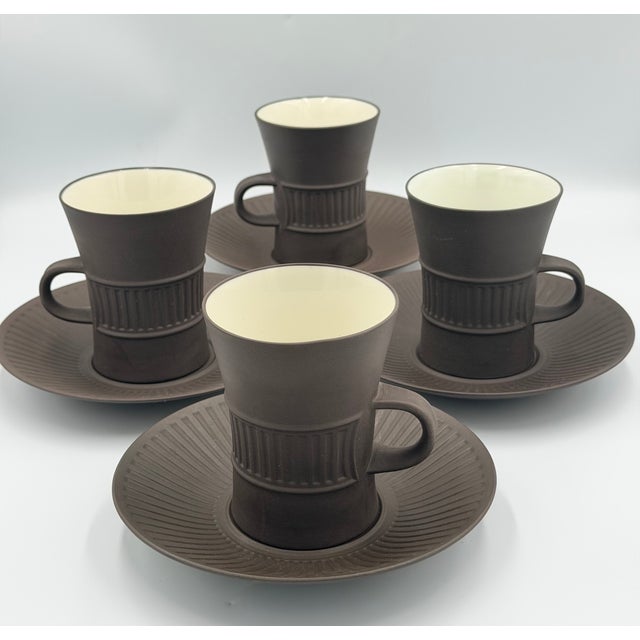 The Dansk Fluted Flamestone Brown cup and saucer is an iconic mid-century modern set designed by Jens Harald Quistgaard...