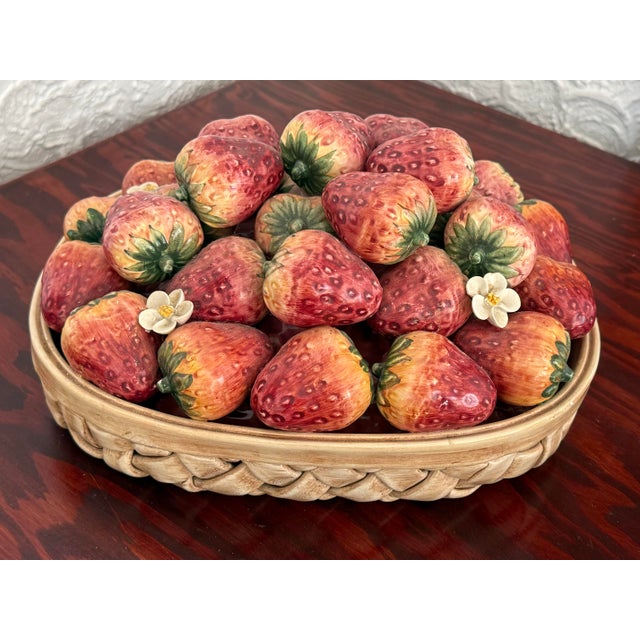 This Italian Majolica centerpiece is a woven ceramic basket heaped with glossy glazed strawberries. Each berry is hand...
