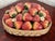 This Italian Majolica centerpiece is a woven ceramic basket heaped with glossy glazed strawberries. Each berry is hand...