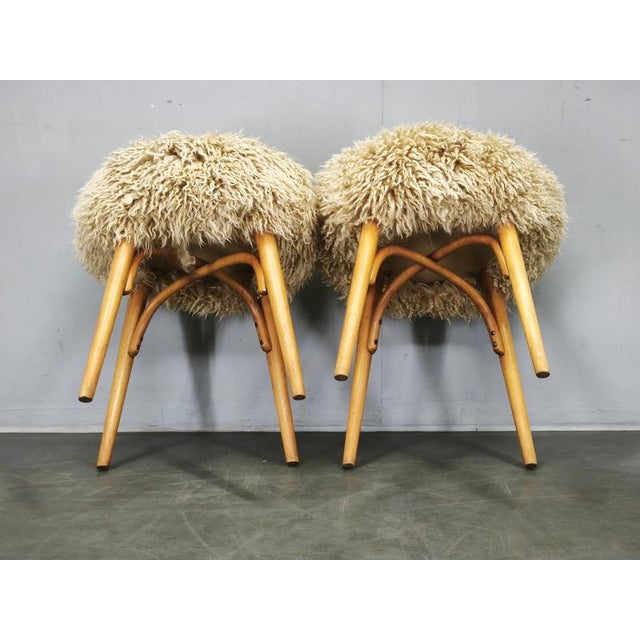 Charming pair of Mid-Century Modern stools originating from Czechoslovakia in the 1950s. The stools feature elegant...