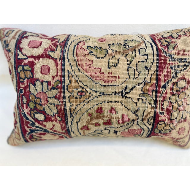 Decorative pillow upholstered in a 19th century Kerman rug fragment, featuring charming floral flowerhead motifs and an...
