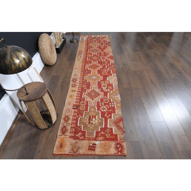 Vintage Hand-Knotted runner rug is a semi-antique vintage area rug. The '70s Eastern region of Anatolia's unique rug is...